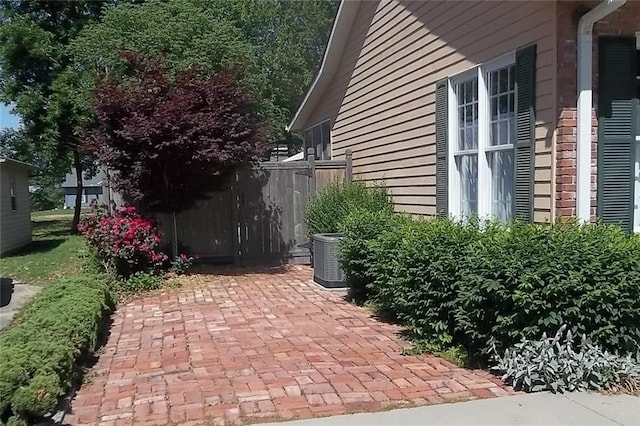 view of patio with fence and central AC