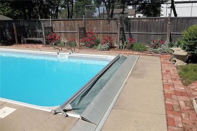 view of pool with a fenced backyard