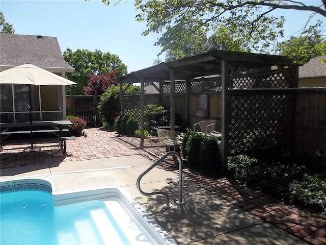view of pool with a pergola, a patio area, and a fenced backyard