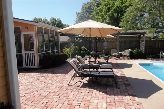 view of patio / terrace with a fenced backyard and a sunroom
