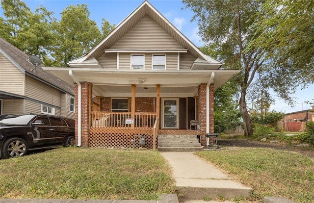 view of front of home featuring a front yard and a porch