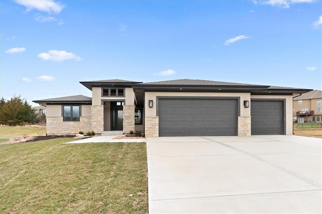 prairie-style home with a front lawn and a garage