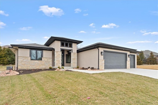 prairie-style house featuring a garage, a front lawn, and central air condition unit