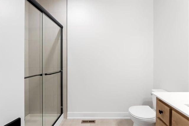 bathroom with vanity, toilet, and an enclosed shower