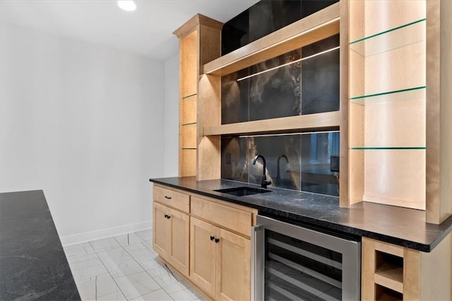 kitchen featuring light brown cabinetry, sink, and beverage cooler