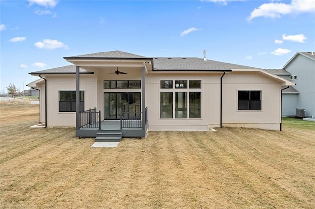 rear view of property with a lawn, ceiling fan, a deck, and central air condition unit