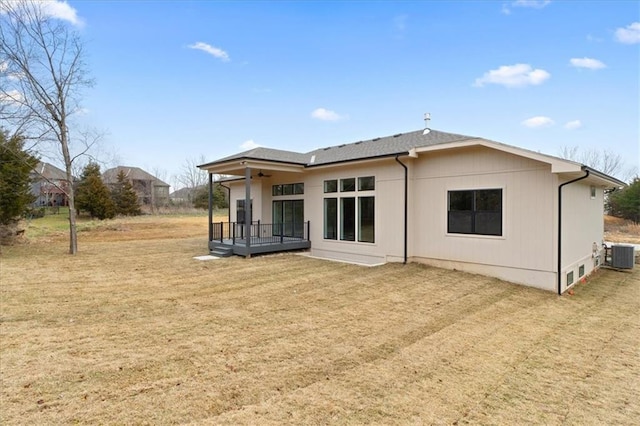 rear view of property featuring a deck, cooling unit, and ceiling fan