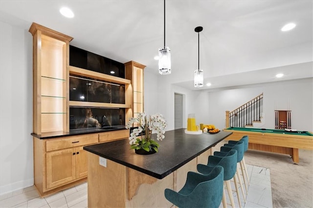 bar with sink, hanging light fixtures, light brown cabinetry, light tile patterned floors, and pool table