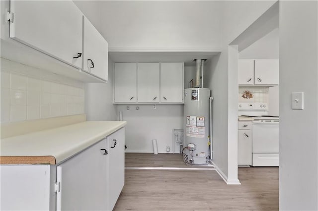 kitchen featuring white range, water heater, light wood-type flooring, and white cabinets