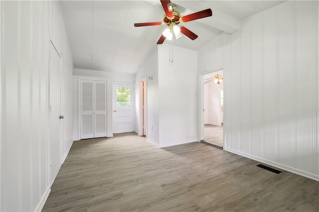 interior space with wood-type flooring, vaulted ceiling with beams, and ceiling fan