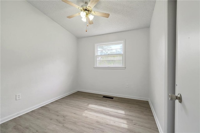 unfurnished room with a textured ceiling, ceiling fan, and light hardwood / wood-style flooring