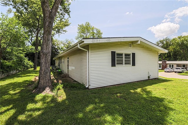 view of side of property with a lawn