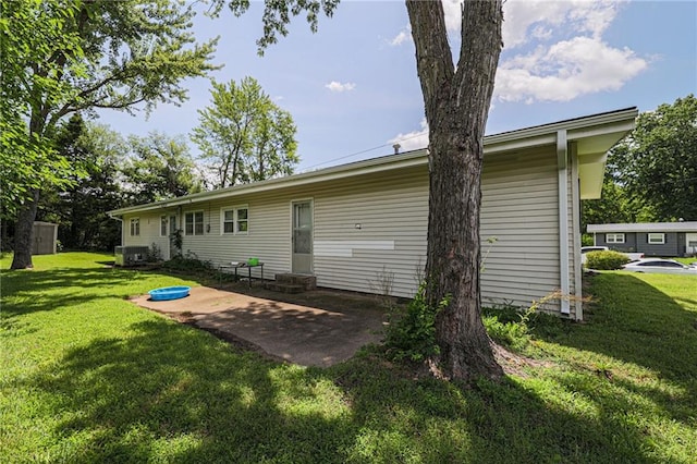 back of house with a yard, a patio, and central air condition unit