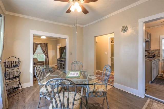 dining area with ornamental molding, dark wood-type flooring, and ceiling fan