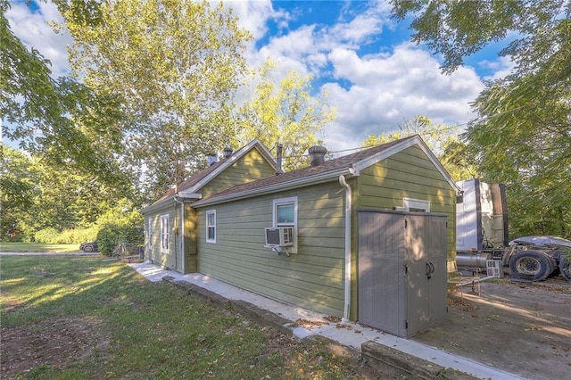 view of home's exterior with cooling unit and a lawn