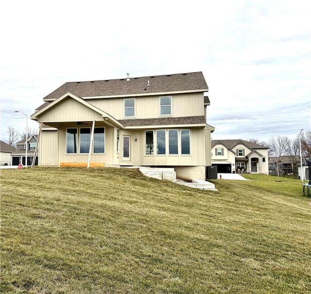 rear view of house featuring a yard