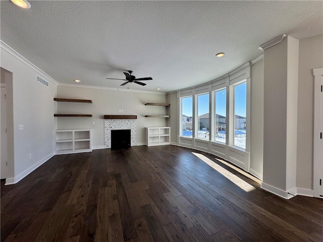 unfurnished living room featuring a tile fireplace, a textured ceiling, ceiling fan, and ornamental molding