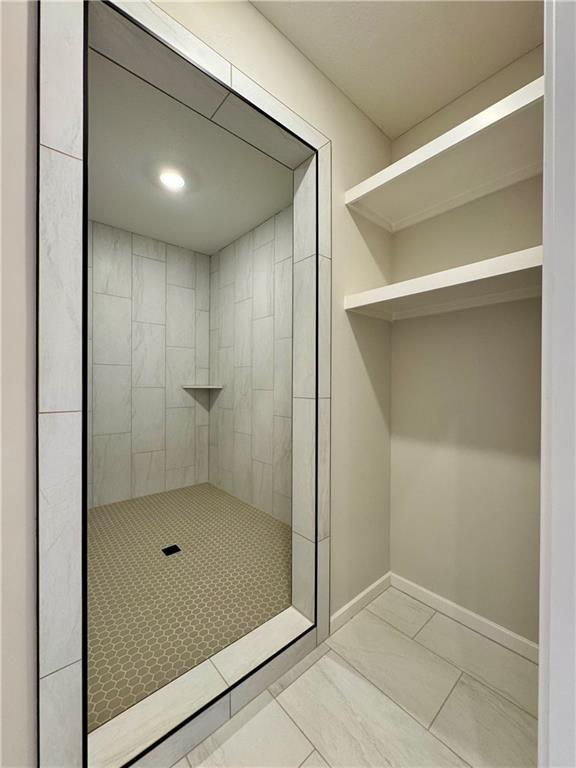 bathroom with tiled shower