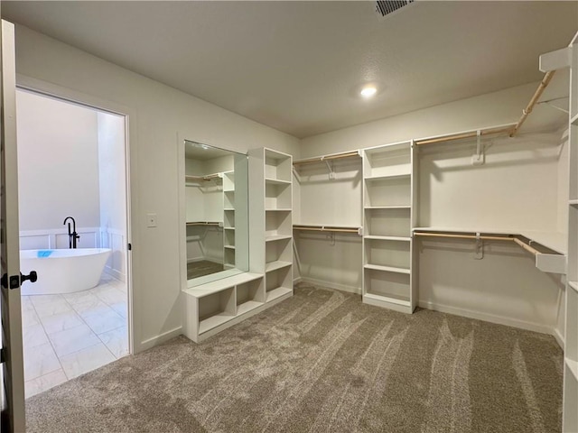 walk in closet with carpet