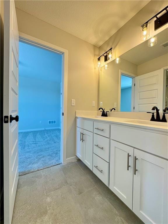 bathroom with a textured ceiling and vanity