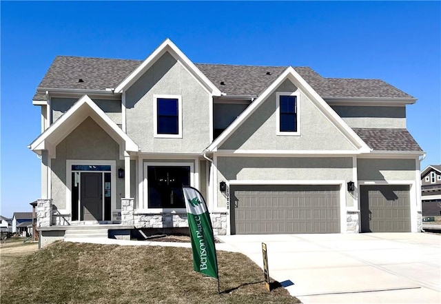 view of front of property featuring stone siding, stucco siding, driveway, and roof with shingles