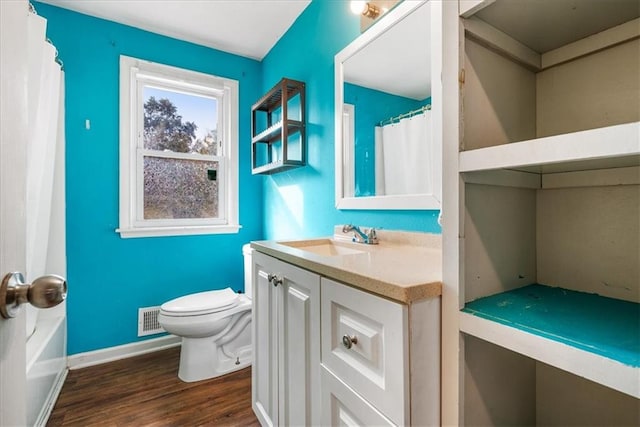 full bathroom with vanity, shower / tub combo, wood-type flooring, and toilet