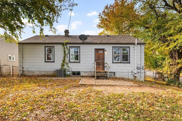 back of house with central AC unit