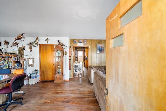 office with wood walls and hardwood / wood-style floors