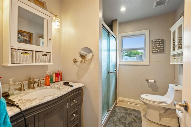 bathroom featuring walk in shower, vanity, and toilet