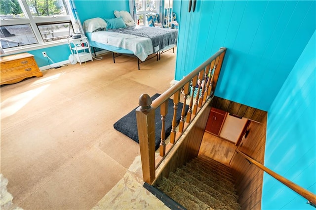 interior space with concrete floors and wooden walls