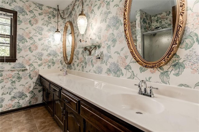 bathroom featuring vanity, a shower with shower door, and tile patterned floors