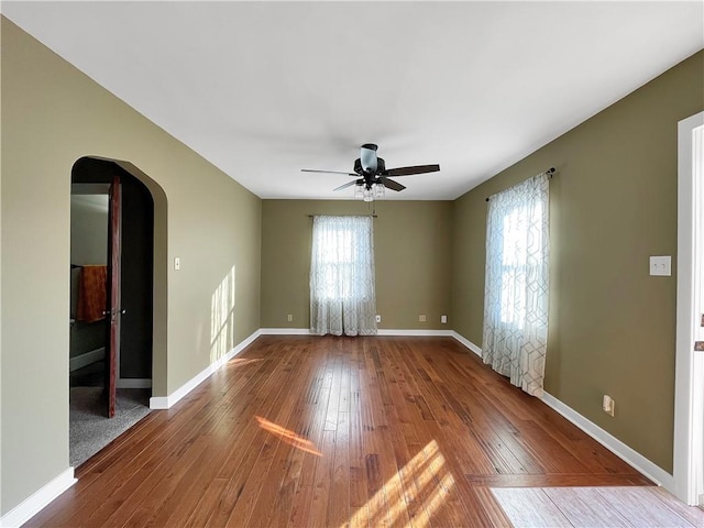 spare room with wood-type flooring and ceiling fan