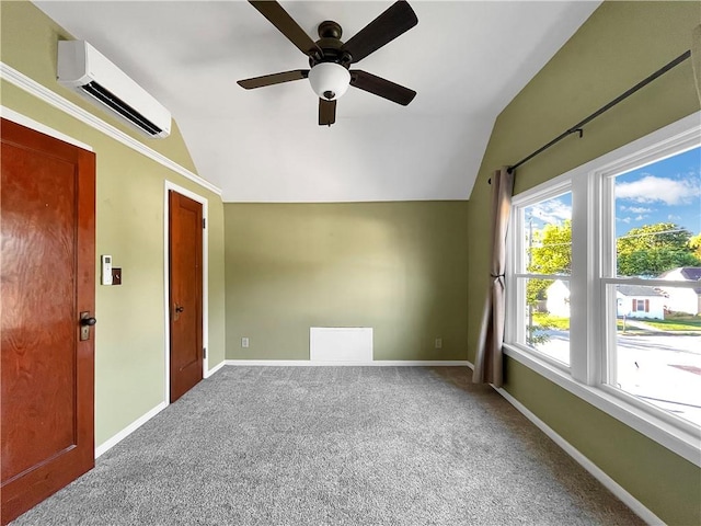 interior space featuring lofted ceiling, a wall mounted AC, carpet flooring, and ceiling fan