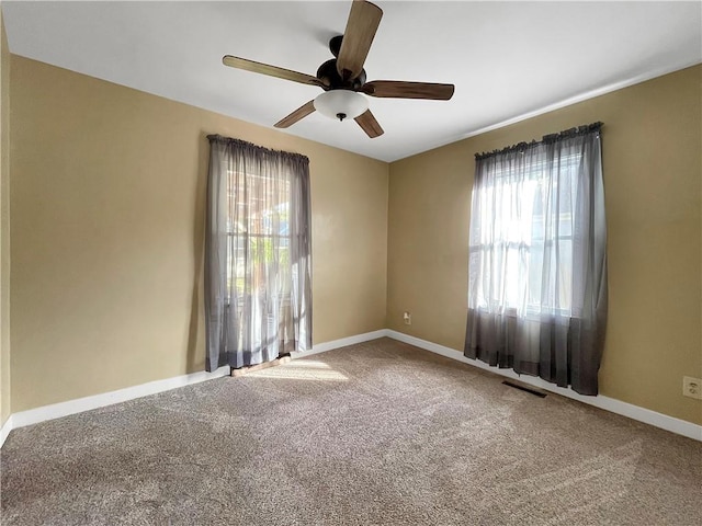 spare room featuring ceiling fan and carpet flooring