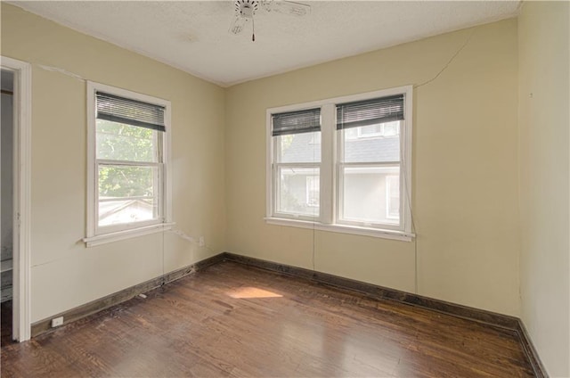 unfurnished room with ceiling fan and dark hardwood / wood-style floors