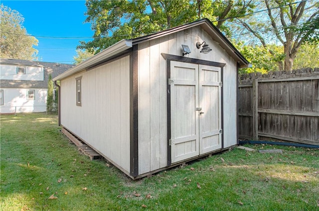 view of outdoor structure featuring a lawn