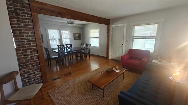 living room featuring hardwood / wood-style flooring and beamed ceiling