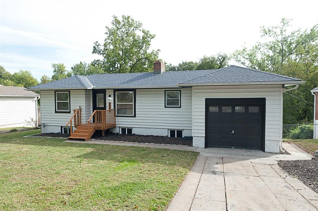 single story home with a garage and a front yard