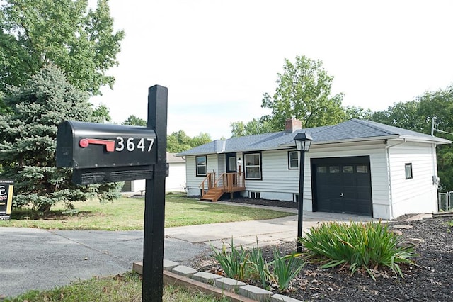 exterior space featuring a front lawn and a garage