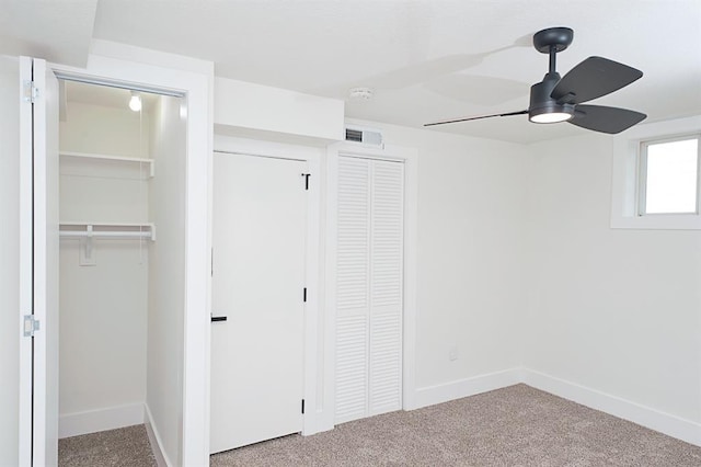 interior space featuring carpet flooring and ceiling fan