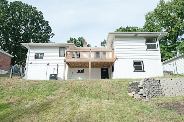 rear view of house featuring a yard and a wooden deck