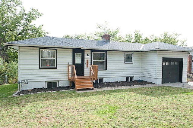 view of front of property with a front yard and a garage