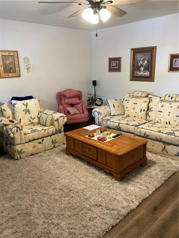 living room featuring ceiling fan and hardwood / wood-style flooring