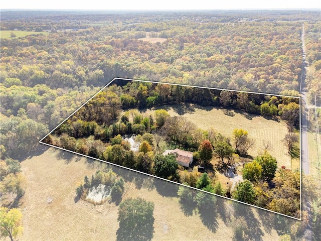 drone / aerial view featuring a view of trees