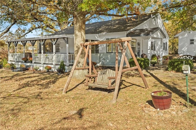 view of jungle gym with a porch and a lawn