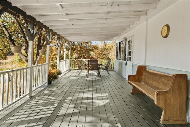 wooden terrace with outdoor dining space
