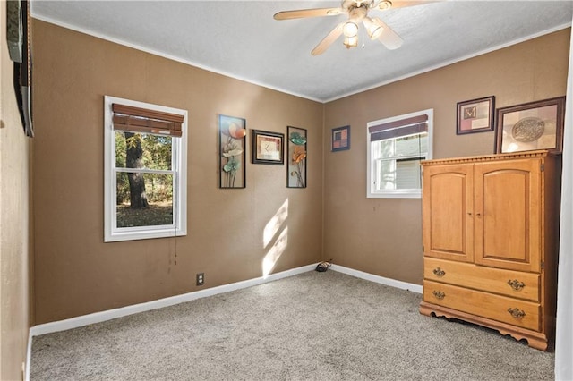 carpeted empty room featuring ceiling fan