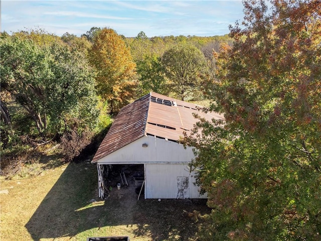 drone / aerial view featuring a wooded view
