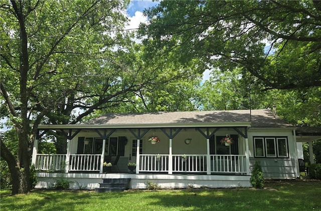 14801 Hamilton Rd, Greenwood, MO 64034 - view of front facade with a porch, a front yard, and roof with shingles