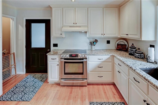 kitchen featuring light stone counters, light hardwood / wood-style floors, electric range, tasteful backsplash, and crown molding